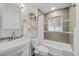 Updated bathroom with a shower/tub combo, modern vanity, and tile surround at 2885 Hudson St, Denver, CO 80207