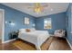 Serene bedroom featuring blue walls, wood floors, and a ceiling fan at 2885 Hudson St, Denver, CO 80207