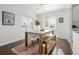 Bright dining room features a wood table with white chairs and bench at 2885 Hudson St, Denver, CO 80207