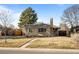 Brick ranch home with a landscaped yard and a driveway at 2885 Hudson St, Denver, CO 80207