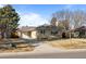 Ranch home with attached garage and a well-manicured lawn at 2885 Hudson St, Denver, CO 80207