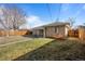 Back exterior of house showing yard and fence at 2885 Hudson St, Denver, CO 80207