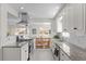 Bright kitchen with white cabinets, granite counters, and stainless steel appliances at 2885 Hudson St, Denver, CO 80207