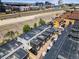 An aerial view displays modern townhomes, railroad tracks, and a parking lot in Denver, Colorado at 3133 Blake St # 3, Denver, CO 80205