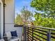 Relaxing balcony offers comfortable seating and views of lush green trees, creating a peaceful outdoor retreat at 3133 Blake St # 3, Denver, CO 80205