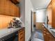 Modern bathroom counter with an espresso machine, compact fridge, wooden cabinets, and a sleek design at 3133 Blake St # 3, Denver, CO 80205