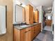 Bathroom showcasing a double vanity with wooden cabinetry, sleek mirrors, and a walk-in closet at 3133 Blake St # 3, Denver, CO 80205