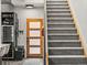Welcoming entryway featuring modern door, stairs, stylish console, and convenient beverage storage at 3133 Blake St # 3, Denver, CO 80205