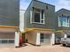A modern townhome exterior features an attached garage, sleek design, and vibrant curb appeal at 3133 Blake St # 3, Denver, CO 80205
