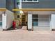 The property has a modern exterior featuring a garage and a red scooter parked in front at 3133 Blake St # 3, Denver, CO 80205