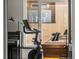 Exercise bike, piano, and natural light from a large window add to this versatile flex room at 3133 Blake St # 3, Denver, CO 80205