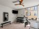 Versatile flex room with a piano, exercise equipment, and natural light from a large window at 3133 Blake St # 3, Denver, CO 80205