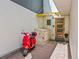 Stylish front entrance with a modern wood door, brick walkway, and a vibrant red scooter parked nearby at 3133 Blake St # 3, Denver, CO 80205