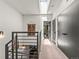 Bright hallway featuring a skylight, sleek black doors, and contemporary wall decor at 3133 Blake St # 3, Denver, CO 80205
