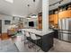 A modern kitchen features a large island with seating, sleek countertops, and stainless steel appliances at 3133 Blake St # 3, Denver, CO 80205