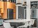 A modern kitchen has a large island with seating, sleek countertops, and wine refrigerators at 3133 Blake St # 3, Denver, CO 80205