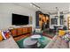 A modern living room features a large sectional sofa, colorful pillows, and a flat screen TV at 3133 Blake St # 3, Denver, CO 80205