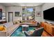 A modern living room features a large sectional sofa, colorful pillows, and a TV at 3133 Blake St # 3, Denver, CO 80205