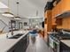 This modern kitchen opens to a living room and features wooden cabinets and an island at 3133 Blake St # 3, Denver, CO 80205