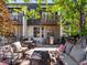 Inviting outdoor patio area complete with comfortable seating, dining area, grill, and decorative string lights at 3133 Blake St # 3, Denver, CO 80205
