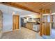 Basement kitchen featuring wooden cabinets, bar seating, and stone accent wall at 96 Carolyn Rd, Evergreen, CO 80439