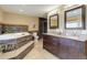 Spacious bathroom featuring double vanity, large soaking tub, and separate shower at 96 Carolyn Rd, Evergreen, CO 80439