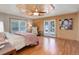 Bright bedroom with hardwood floors, ceiling fan, and access to the outdoors through French doors at 96 Carolyn Rd, Evergreen, CO 80439