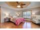 Comfortable bedroom with wood floors, decorative ceiling, and large window providing natural light at 96 Carolyn Rd, Evergreen, CO 80439
