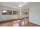 Bright bedroom with multiple windows, closet with mirror doors, and wood floors at 96 Carolyn Rd, Evergreen, CO 80439