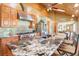 Spacious kitchen features custom cabinets, stainless steel appliances, and granite countertops with a view into the dining room at 96 Carolyn Rd, Evergreen, CO 80439