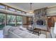 Bright living room with hardwood floors, large stone fireplace, big windows and stylish, comfortable furnishings at 96 Carolyn Rd, Evergreen, CO 80439