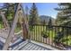 Enjoy the porch swing with views of the mature pines and serene mountain landscape at 96 Carolyn Rd, Evergreen, CO 80439