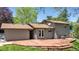 Home exterior showcasing a wooden deck, well maintained lawn and neutral paint at 1250 Acropolis Dr, Lafayette, CO 80026