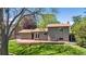 Home exterior with a fenced yard, wooden deck and mature trees at 1250 Acropolis Dr, Lafayette, CO 80026