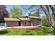 Rear exterior featuring a wood deck, lawn and shade trees at 1250 Acropolis Dr, Lafayette, CO 80026