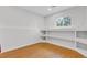 Bonus room features laminate flooring, a window for natural light, and built-in shelving at 1250 Acropolis Dr, Lafayette, CO 80026