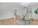 Open-concept dining area featuring wood floors, chandelier, and a glass table set for four at 1250 Acropolis Dr, Lafayette, CO 80026