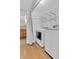 Bright laundry room with washer, dryer, wire shelving and wood-look flooring at 1250 Acropolis Dr, Lafayette, CO 80026