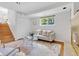 Cozy living room featuring a fireplace, large window, and access to stairs at 1250 Acropolis Dr, Lafayette, CO 80026