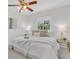 Serene bedroom with large window, soft carpet, ceiling fan, and neutral decor for a relaxing retreat at 1250 Acropolis Dr, Lafayette, CO 80026