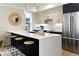 Modern kitchen island with white countertop and black cabinetry at 1260 N Stuart St # 2, Denver, CO 80204