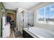 Bathroom with soaking tub and walk-in shower at 7097 S Patsburg Way, Aurora, CO 80016