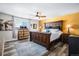 Large bedroom with ceiling fan and wood furniture at 7097 S Patsburg Way, Aurora, CO 80016