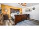 Large bedroom with ceiling fan and wood furniture at 7097 S Patsburg Way, Aurora, CO 80016