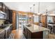 Eat-in kitchen with dark cabinetry, granite counters, and stainless steel appliances at 7097 S Patsburg Way, Aurora, CO 80016