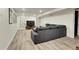 Finished basement Gathering room with gray sectional sofa and wood-look flooring at 3126 S Franklin St, Englewood, CO 80113