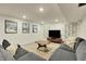 Finished basement recreation area featuring comfortable seating and a large TV at 3126 S Franklin St, Englewood, CO 80113