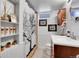 Basement bathroom with a shower, wood vanity, and decorative accents at 3126 S Franklin St, Englewood, CO 80113