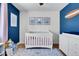 Bedroom with crib, dresser and blue walls at 3126 S Franklin St, Englewood, CO 80113