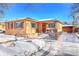 Brick ranch home with a snow-covered front yard, driveway, and attached garage at 3126 S Franklin St, Englewood, CO 80113